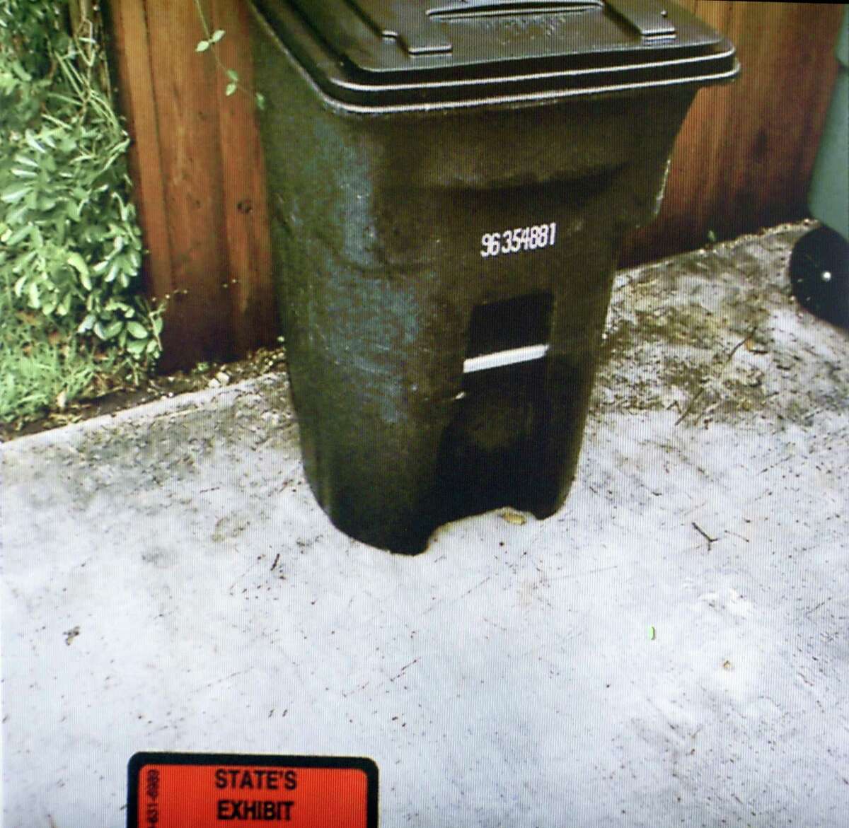 Former San Antonio police officer Emmanuel Galindo's trash can where two hard drives were found is seen in an evidence photo presented in his trial Wednesday, March 1, 2017. Galindo is on trial, with fellow former police officer Alejandro Chapa, for charges of compelling prostitution, official oppression and aggravated sexual assault in 2015. Chapa and Galindo are accused of recruiting and duping women into having sex with them. The photo was taken during a search of Galindo's home after several law enforcement agencies began investigating the alleged crimes.