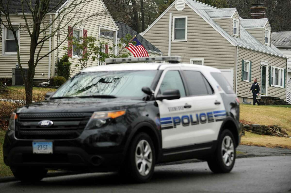 A Stamford police officer goes door to door on High Clear Dr. asking residents if they have any information of the recent act of vandalism in Stamford, Conn. on Wednesday, March 1, 2017.