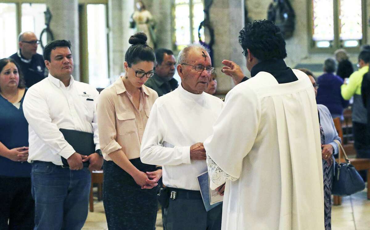 Acolyte Rudy Rodriguez performs the service of applying of the ashes at San Fernando Cathedral on March 1, 2017.
