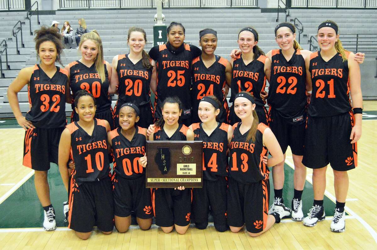The Edwardsville girls’ basketball team poses with the Class 4A Illinois Wesleyan Super-Sectional plaque after beating Lisle Benet Academy on Monday in Bloomington.
