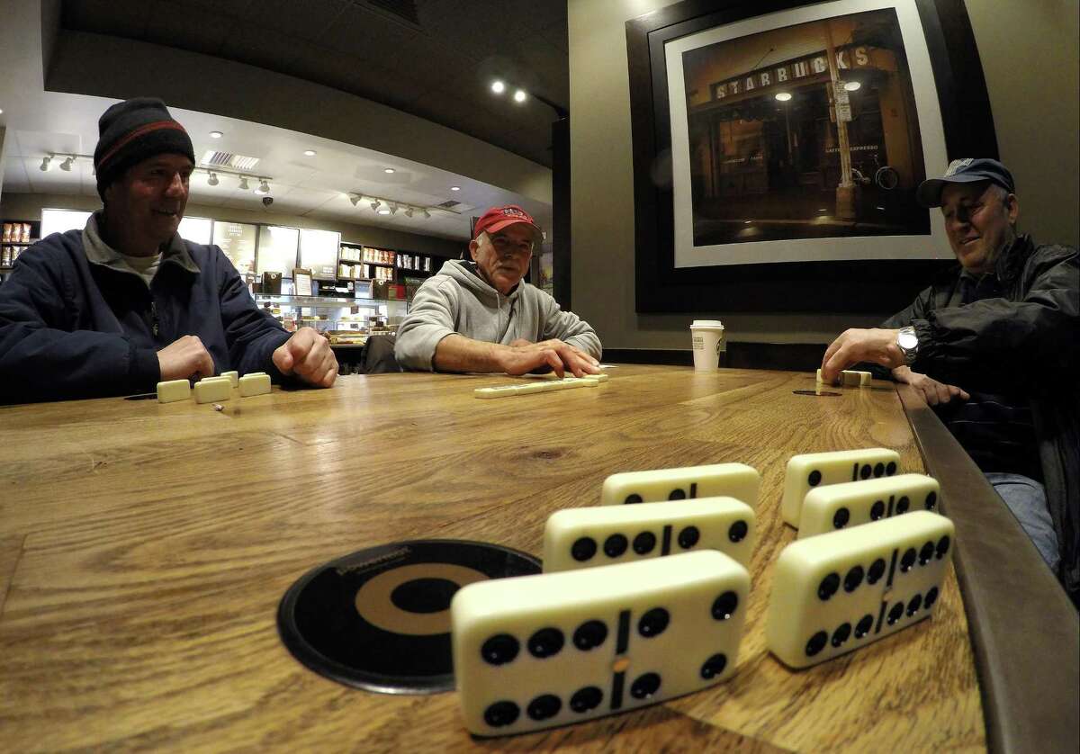 From left, Izzy Krasniqi, Martin Merturi and Akija Elizaj, all of Stamford, play a game of Dominoes at a Starbucks in Stamford, Conn. on Feb. 22, 2017. The group of gentlemen, who have known each other for several years, meet at the West side coffeehouse several times in a week to play variations of the game for several hours, sometimes til closing.