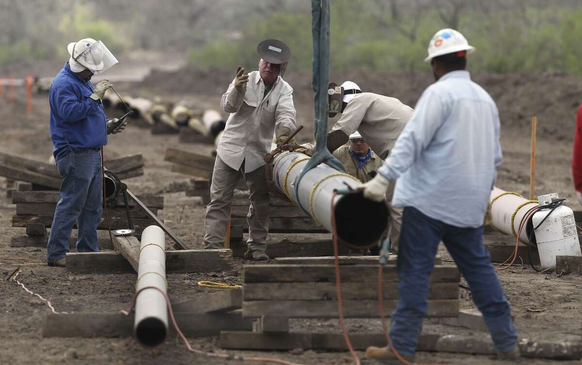 Welding crews work on an oil and gas pipeline east of Karnes City. A 730-mile crude oil and condensate pipeline is in the works from West Texas to Corpus Christi. When completed, it would be able to transport 440,000 barrels a day from West Texas alone.