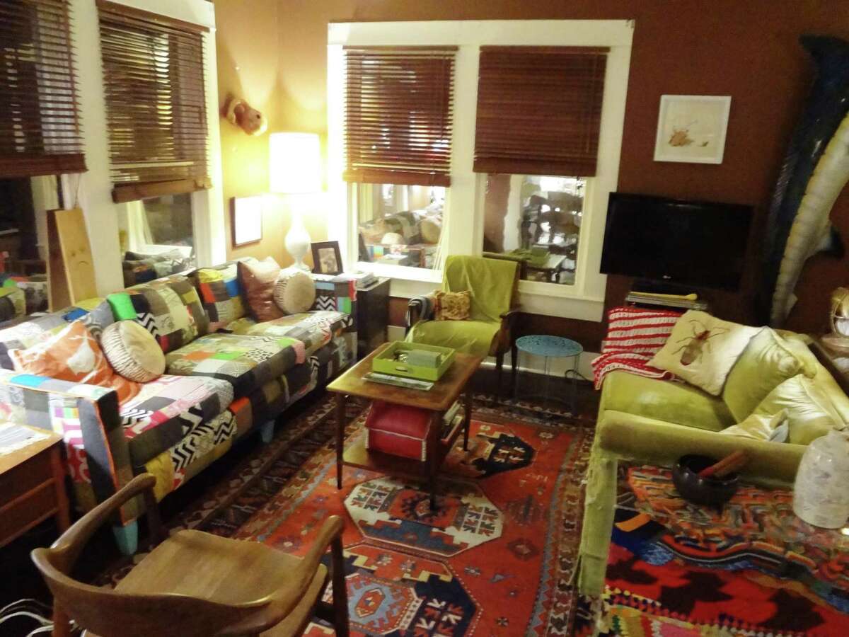 The living room features comfortable furniture and a wide variety of colors, textures and patterns. The quilted cushion covers on the couch at left can be easily replaced if felines Chuckie and Frankie get cat scratch fever.