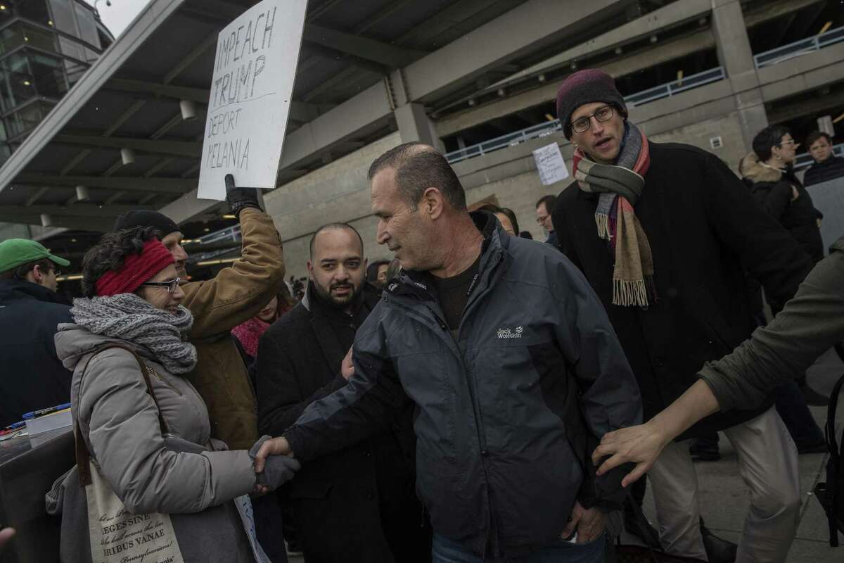 FILE -- Hameed Khalid Darweesh, center, a former interpreter for the US military in Iraq, greets a supporter after his release from detention outside of John F. Kennedy International Airport, in New York, Jan. 28, 2017. A government list shows 746 travelers were detained in a 26-hour period immediately after a federal judge temporarily blocked part of Trump?•s Jan. 27 order, according to a list released by the government. (Victor J. Blue/The New York Times)