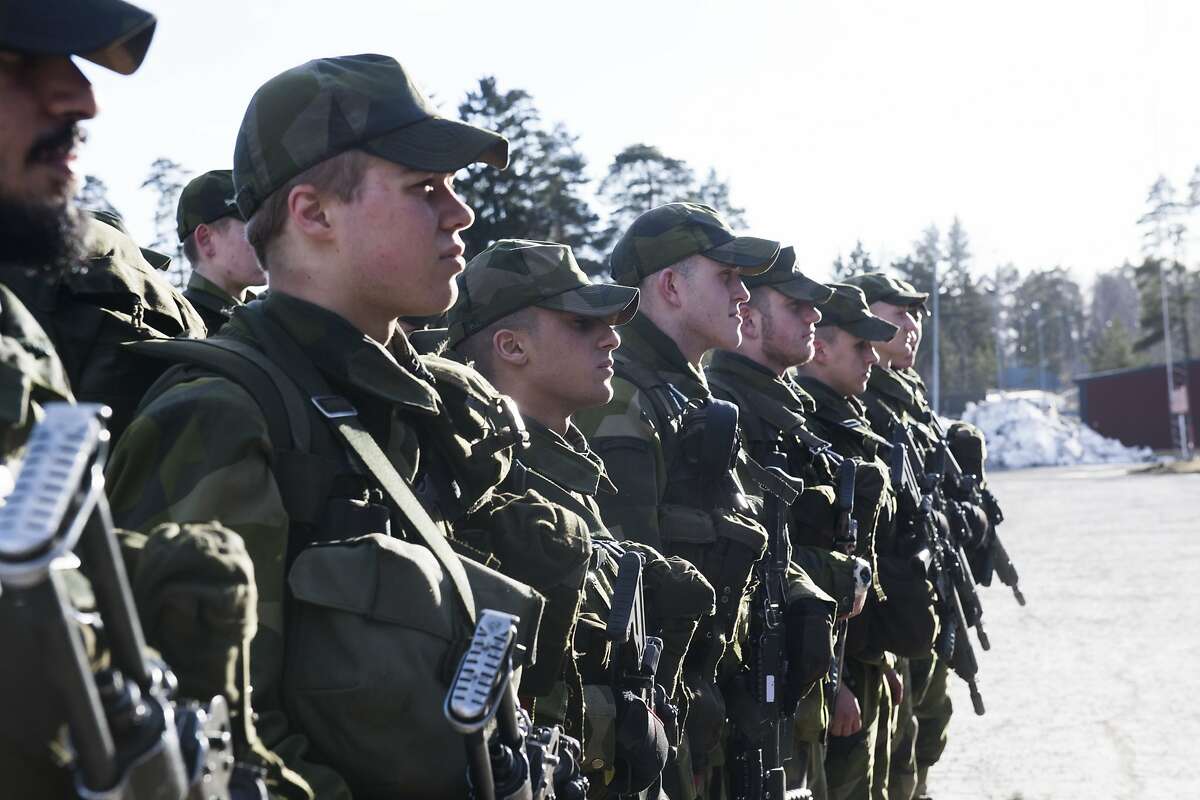 Young recruits during an inspection, Thursday, March 2, 2017 at the regiment in Enkoping 70 km north-west of Stockholm, Sweden. Sweden's left-leaning government introduced a military draft for both men and women Thursday because of what its defense minister called a deteriorating security environment in Europe and around Sweden. (Fredrik Sandberg /TT via AP)