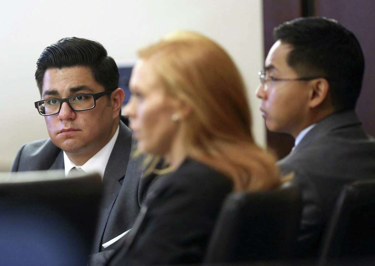 Former San Antonio Police officers Alejandro Chapa, left and Emmanuel Galindo, right. listen to testimony Wednesday, March 1, 2017 with one of their attorneys, Leigh Cutter. The officers are on trial for charges of compelling prostitution, official oppression and aggravated sexual assault in 2015. Chapa and Galindo are accused of recruiting and duping women into having sex with them.