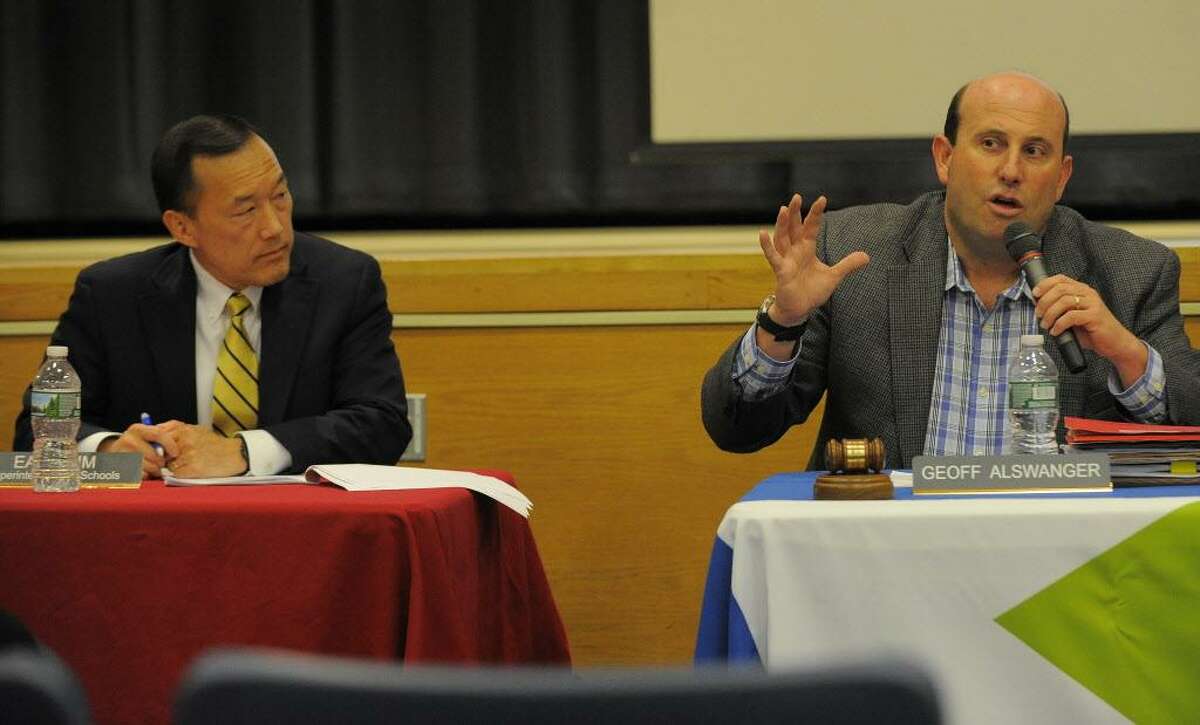 FILE — Board member Geoff Alswanger, right, welcomes Superintendent Earl Kim to present his proposed budget to members of the Stamford Schools Board of Education during a public hearing at Westover Magnet Elementary School in Stamford on Feb. 7, 2017.