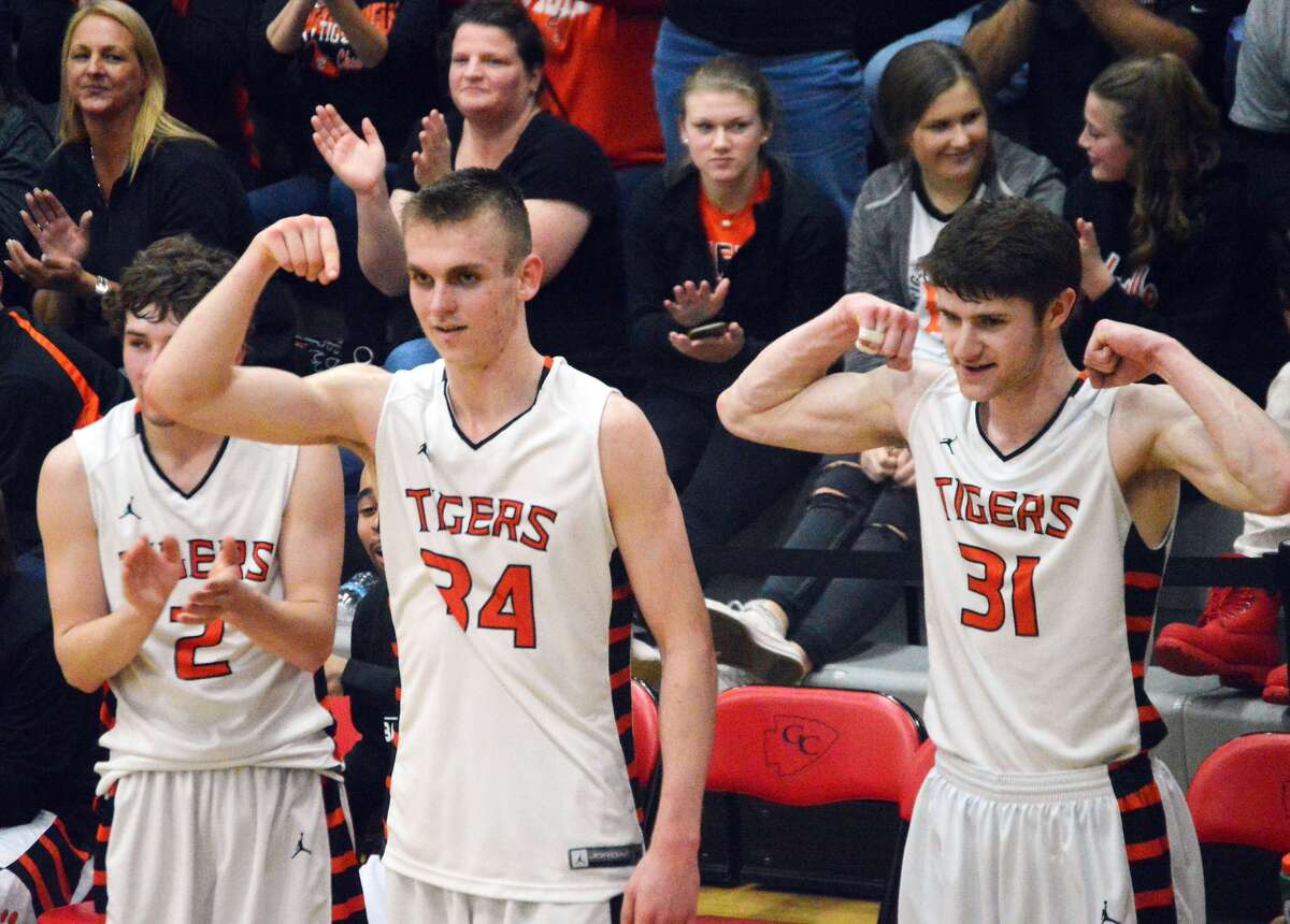 Edwardsville’s Jack Marinko, left, Caleb Strohmeier, center, and Oliver Stephen celebrate on the bench during a win over Chatham Glenwood on Tuesday.