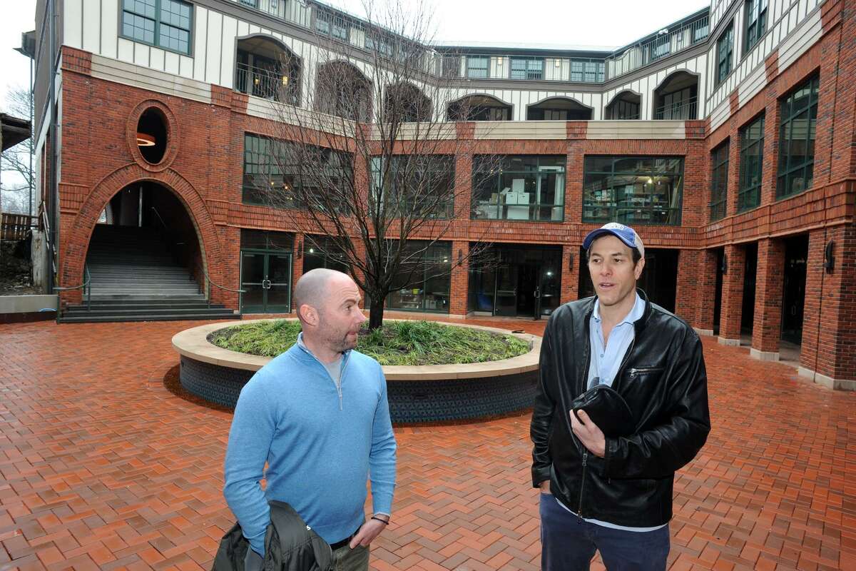 Developers Dan Zelson, left, and David Waldman speak in the central courtyard of Bedford Square.
