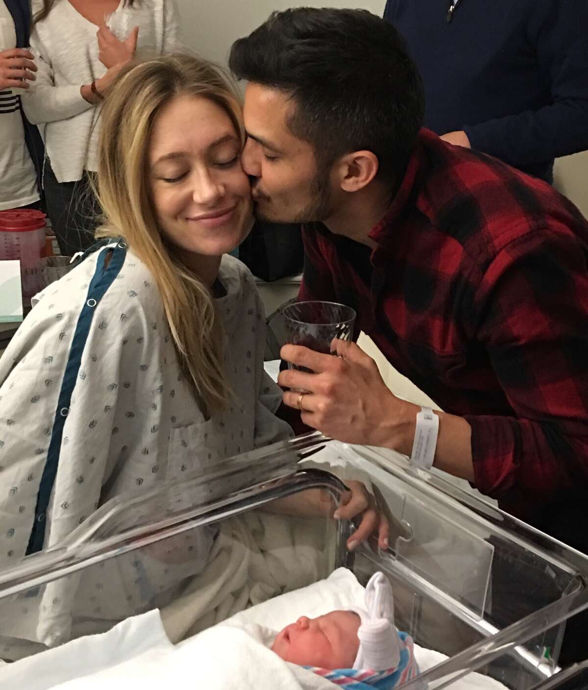 San Antonio-born TV star Nicholas Gonzalez kisses his beloved wife, Kelsey Crane, after the birth of their first child: a daughter named Ever Lee Wilde Gonzalez.