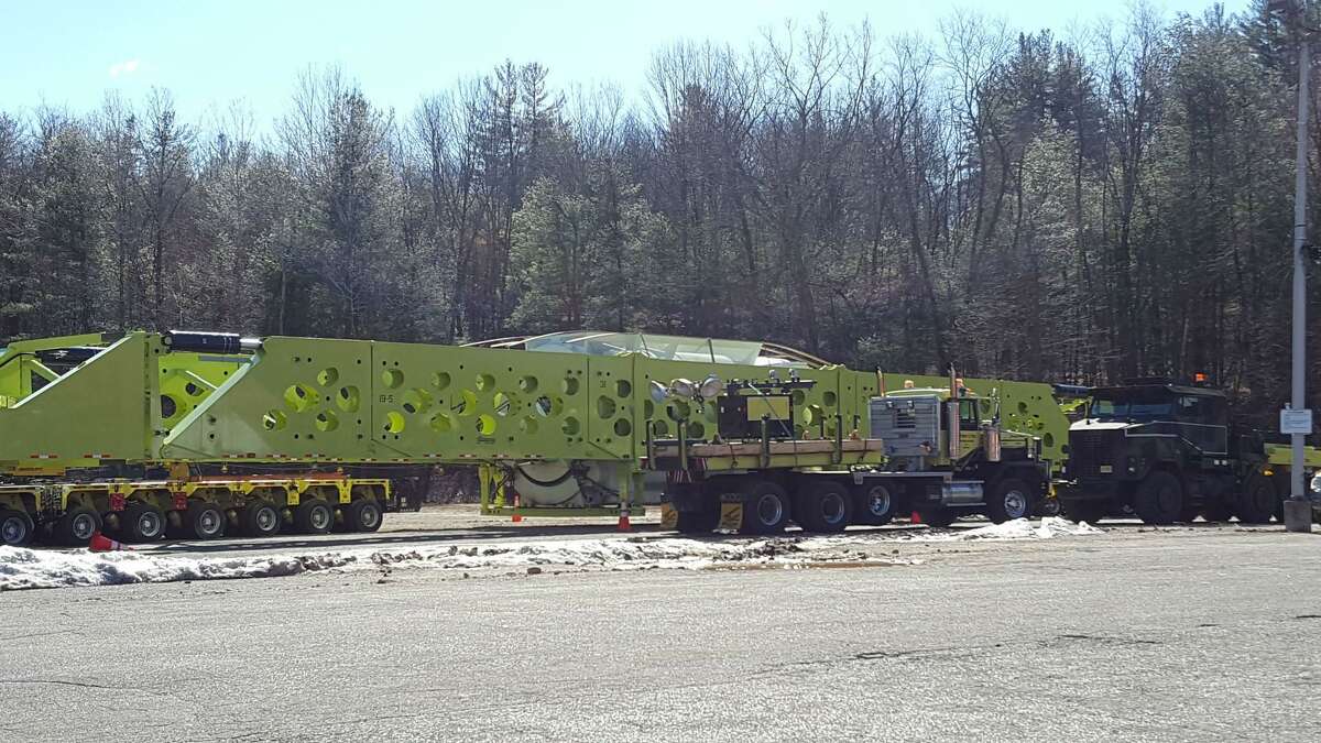 In this image from the town of Barkhamsted's Facebook page, a large piece of equipment slated for the power plant under construction in Oxford waits by the side of the road along its journey from Windsor Locks.