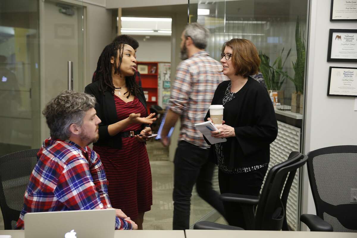 Mother Jones' editor in chief Clara Jeffery (right) talks with Jahna Berry (center), director of news product and Clint Hendler (left), news director after a news meeting on Thursday, March 2, 2017 in San Francisco, Calif.