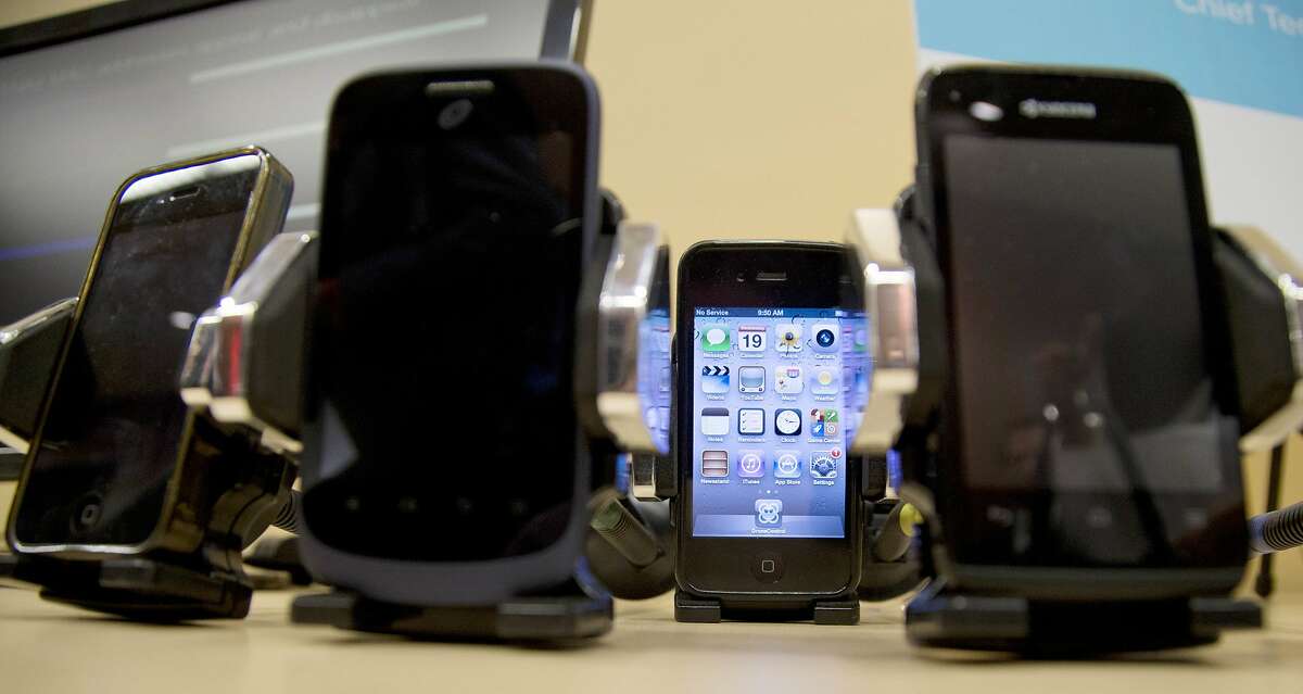 FILE - This Wednesday, Feb. 19, 2014 file photo shows a display of cell phones during a Federal Trade Commission (FTC) mobile tracking demo in Washington. On Friday, May 27, 2016, National Institutes of Health expert reviewers said they are finding flaws in the agency's new study that connects heavy cellphone radiation to a slight increase in brain tumors in male rats. (AP Photo/Carolyn Kaster)