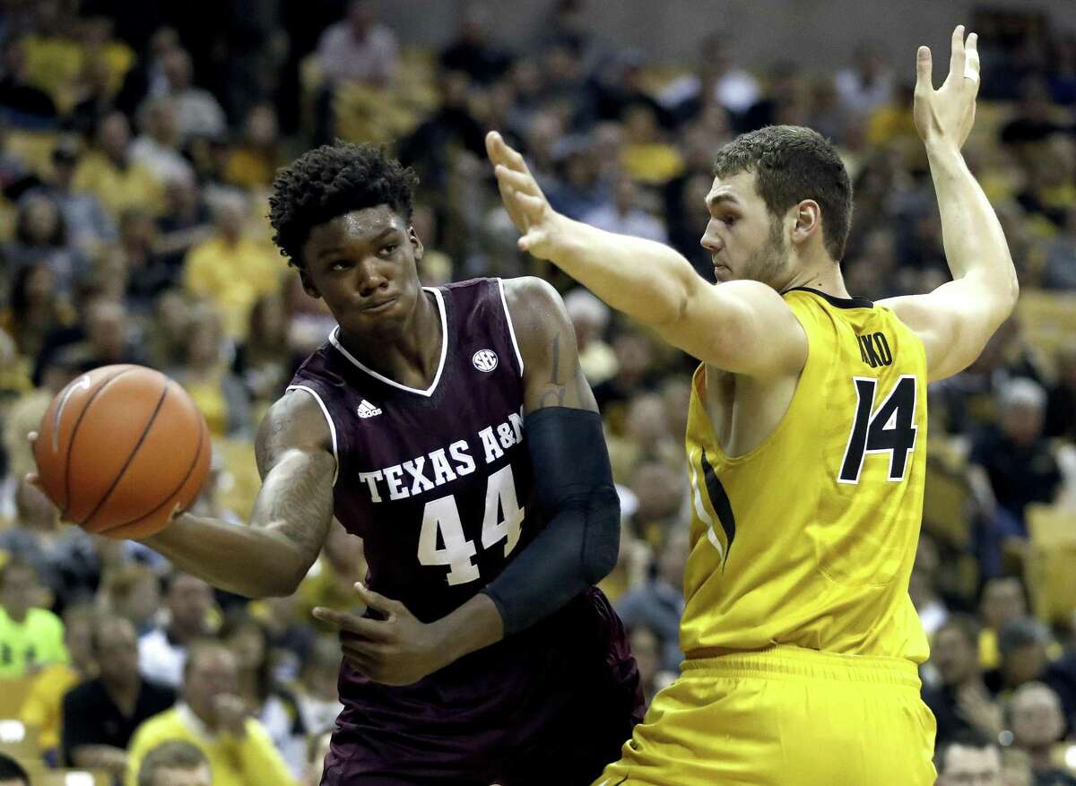 Texas A&M’s Robert Williams (44) passes around Missouri’s Reed Nikko (14) during the first half on Feb. 28, 2017, in Columbia, Mo.
