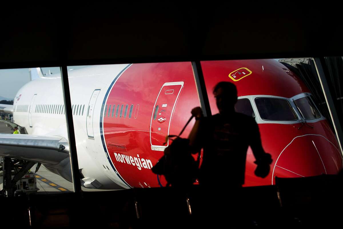 A passenger prepares to board a Stockholm-bound Norwegian Air flight at Oakland International Airport on Friday, March 3, 2017, in Oakland, Calif.