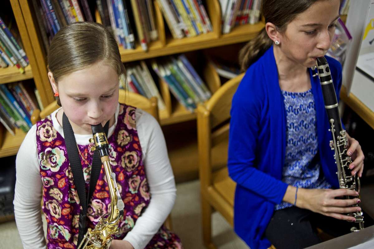 In this file photo, from left, Plymouth Elementary students Nala Jones and Grace Riddle play music as part of their presentation focused on music and mood during a Primary Years Programme (PYP) exhibition at Plymouth Elementary School. 