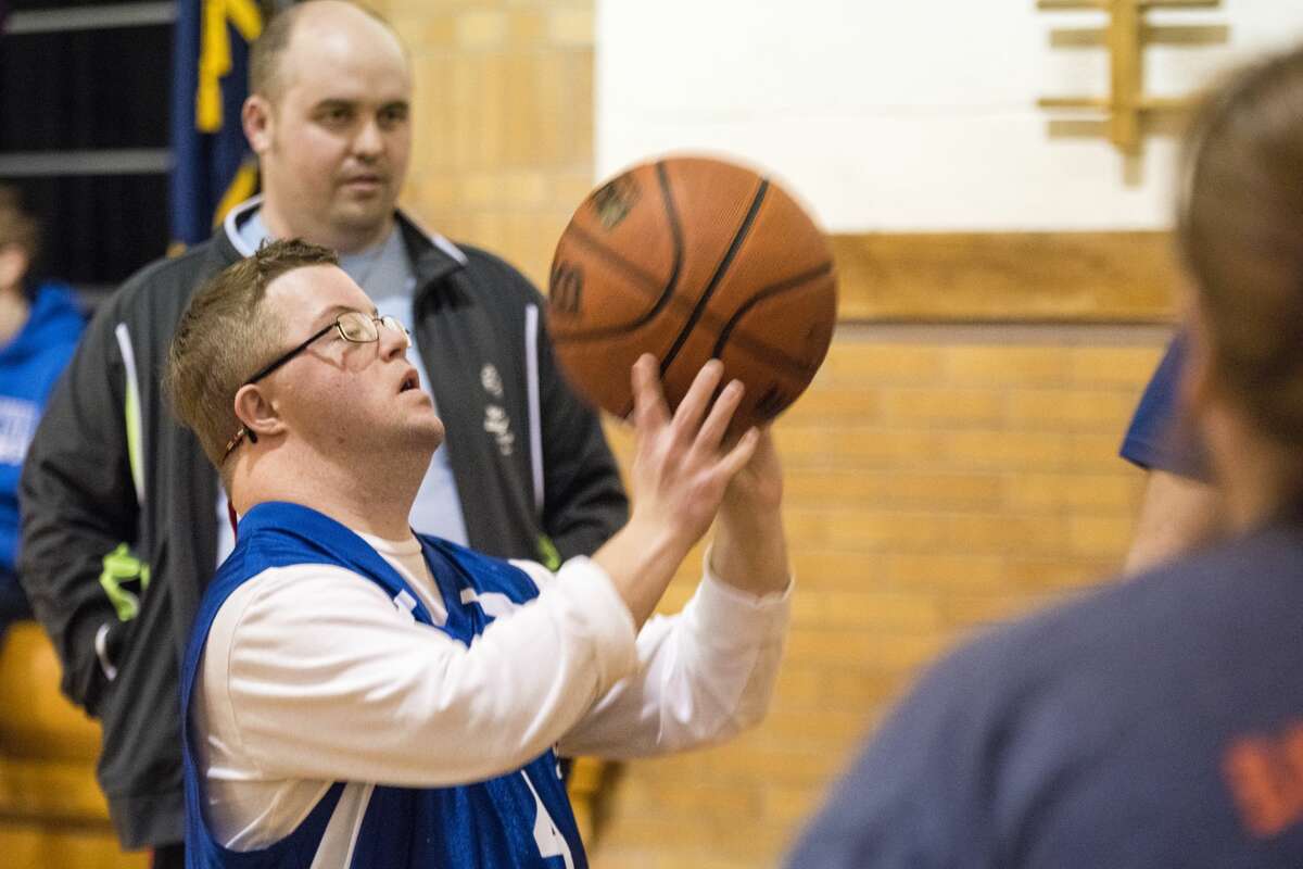 Bay City Area 9 Special Olympics athlete Duane McCann takes a shot during the Special Olympics Skills Tournament on Friday at Eastlawn Elementary School in Midland. McCann placed first in his division of the 10-meter dribble event.