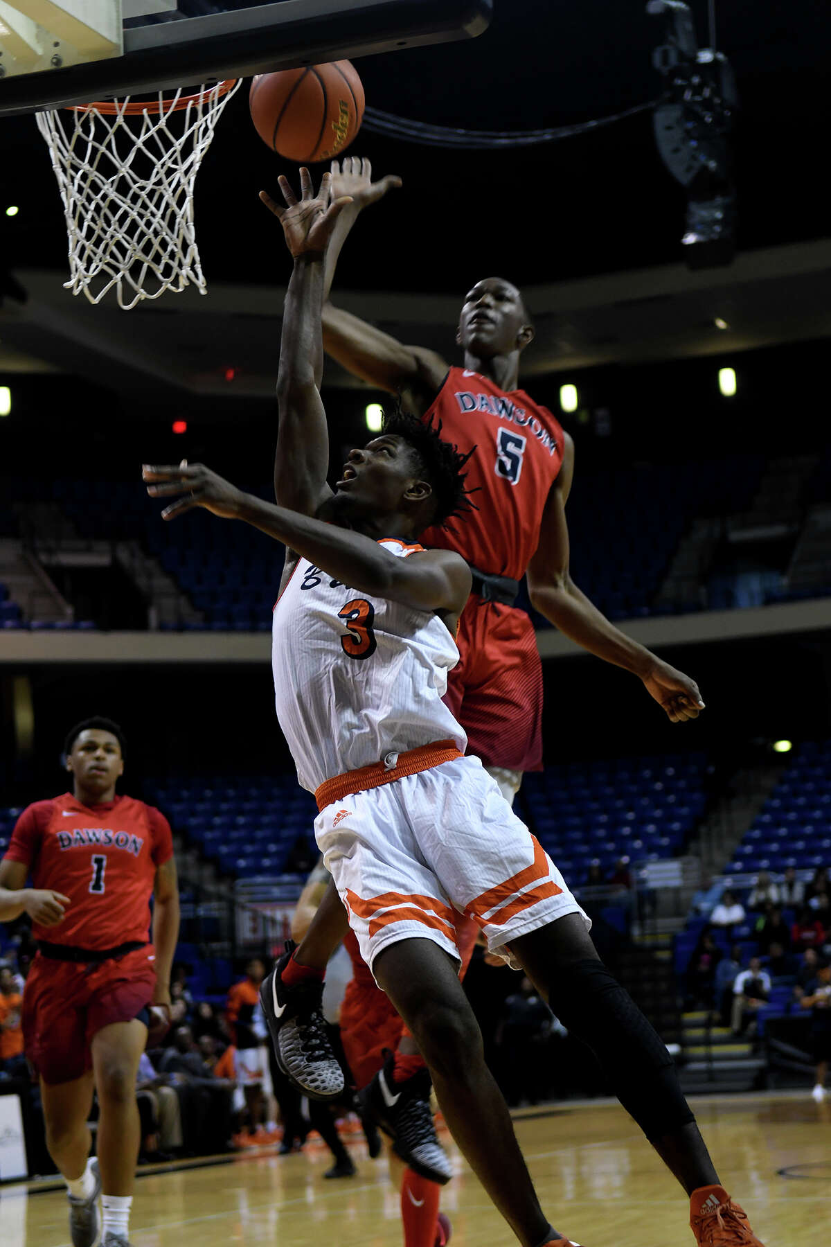 Fort Bend Bush senior forward Trevion Bradley shoots against Pearland Dawson senior forward Karl Nicholas (5) during the 1st quarter of their Class 6A Region III Boys Basketball semifinal at the Richard E. Berry Center in Cypress on Friday, March 3, 2017. (Photo by Jerry Baker/Freelance)