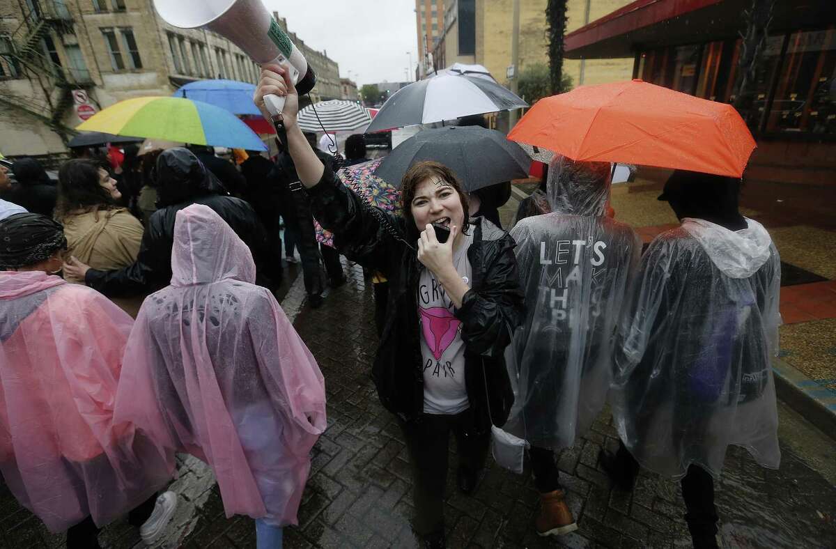 Rosalind Casey yells into a bullhorn as hundreds march despite the rain for the 27th Annual San Antonio International Woman's Day March and Rally on Saturday, Mar. 4, 2017. Local activist group Mujeres Marcharan hosted the event which started at Milam Park and then took to the downtown streets for about two miles before concluding back at the park. A steady rain fell but organizers and participants were undaunted in getting their voices heard. (Kin Man Hui/San Antonio Express-News)