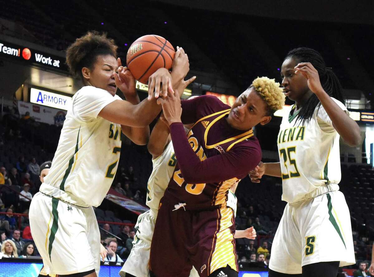 Kollyns Scarbrough, left, of Siena fights for a rebound with Iona?’s Alexis Lewis during the first half at the MAAC Tournament on Saturday afternoon, March 4, 2017, at the Times Union Center in Albany, N.Y. (Will Waldron/Times Union)