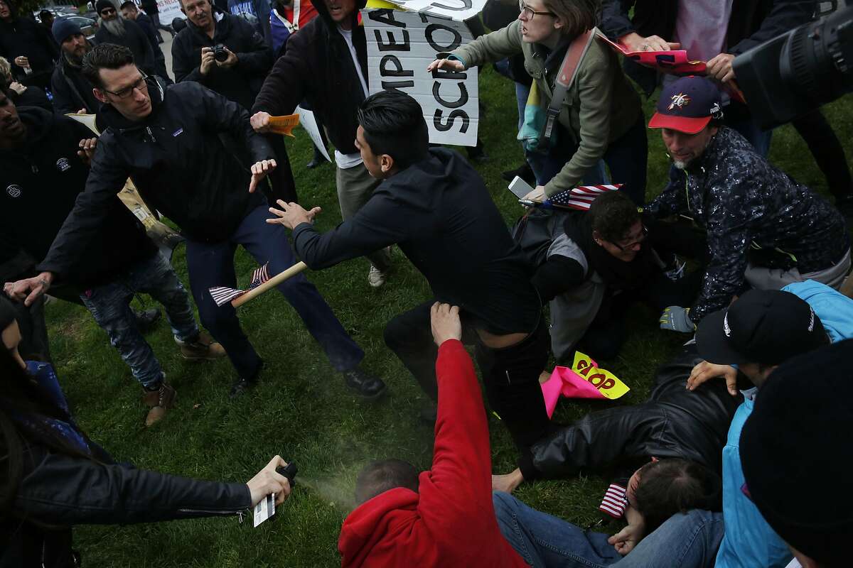 A Trump supporter gets pepper-sprayed as anti-fascist and Trump supporters brawl during a Pro-President Donald Trump rally and march at the Martin Luther King Jr. Civic Center park March 4, 2017 in Berkeley, Calif.