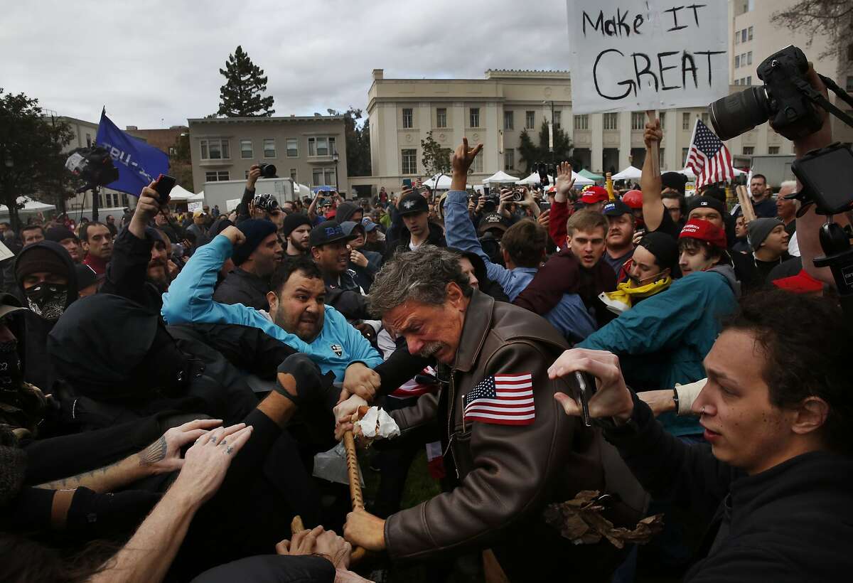 Tom Condon of San Francisco, center, a Trump supporter, becomes entangled in the center of a fight after attempting to push protesters back with his cane during a Pro-President Donald Trump rally and march at the Martin Luther King Jr. Civic Center park March 4, 2017 in Berkeley, Calif.