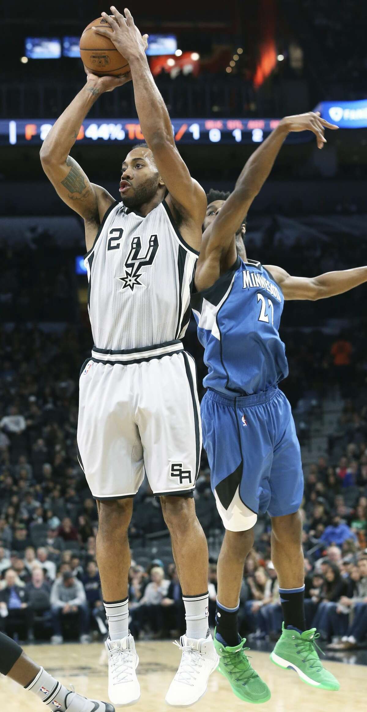 Kawhi Leonard takes a jumper after faking Andrew Wiggins in the first half as the Spurs host the Timberwolves at the AT&T Center on March 4, 2017.