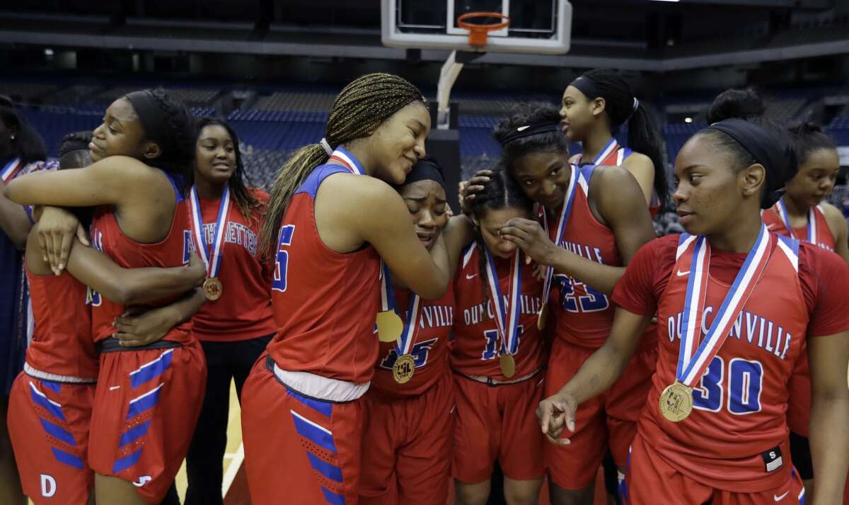 Duncanville players celebrate a win over Houston Cypress Ranch in the UIL girls' Class 6A state basketball final, Saturday, March 4, 2017, in San Antonio. (AP Photo/Eric Gay)