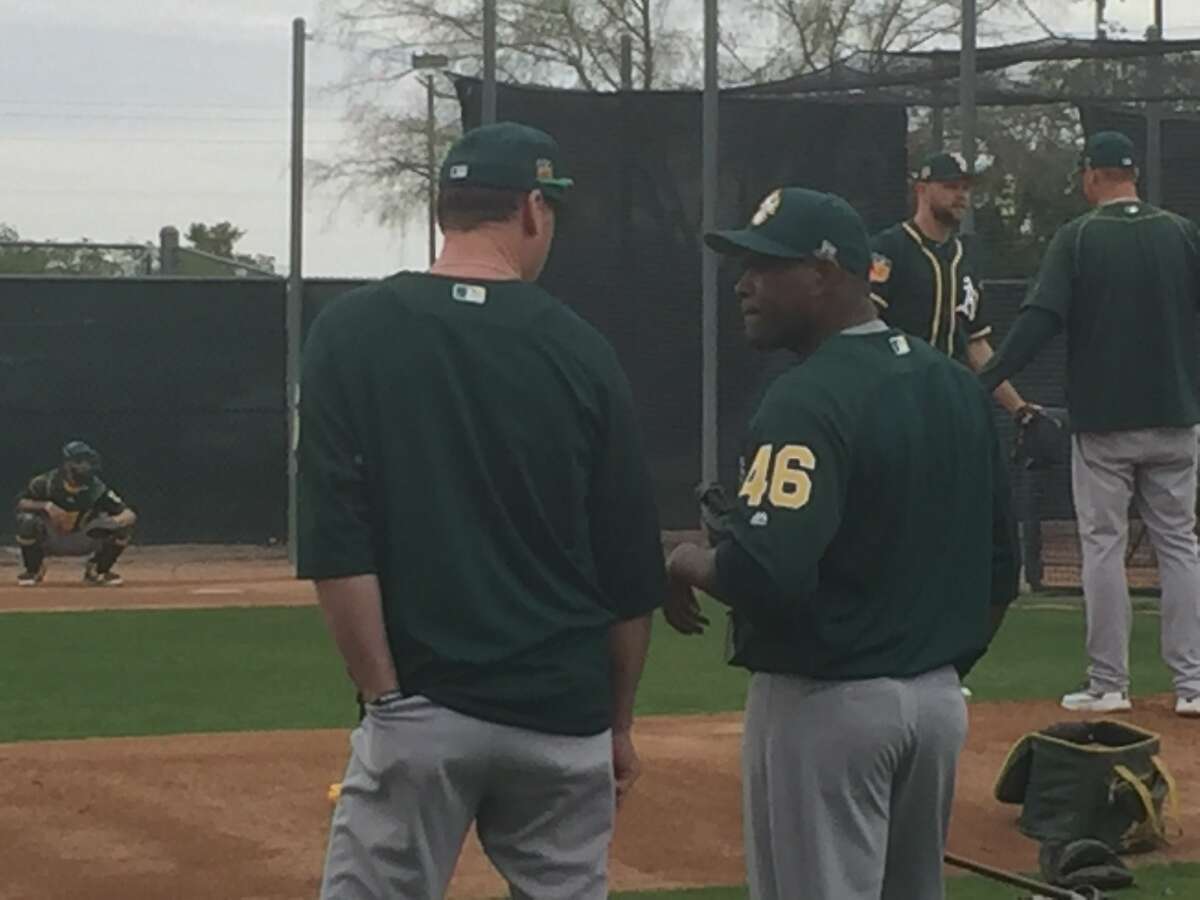 Santiago Casilla chats with Oakland Athletics manager Bob Melvin at spring training in Mesa, Ariz., on March 5, 2017.
