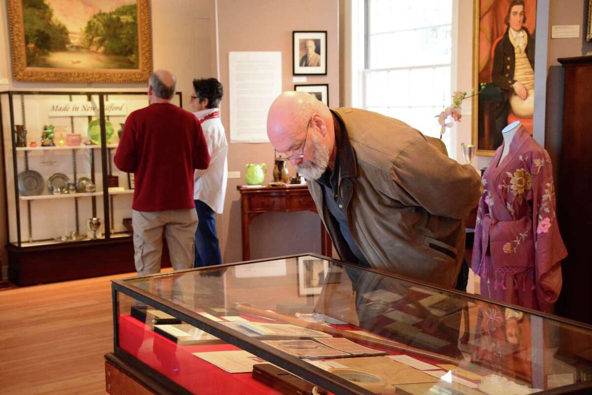 Greg Holmes, a Social Studios teacher at New Milford HIgh School, studies some of the artifacts during The New Milford Historical Society's opening of it's WW1 exhibit honorong the roll of woman in the war on Sunday, March 5, 2017.