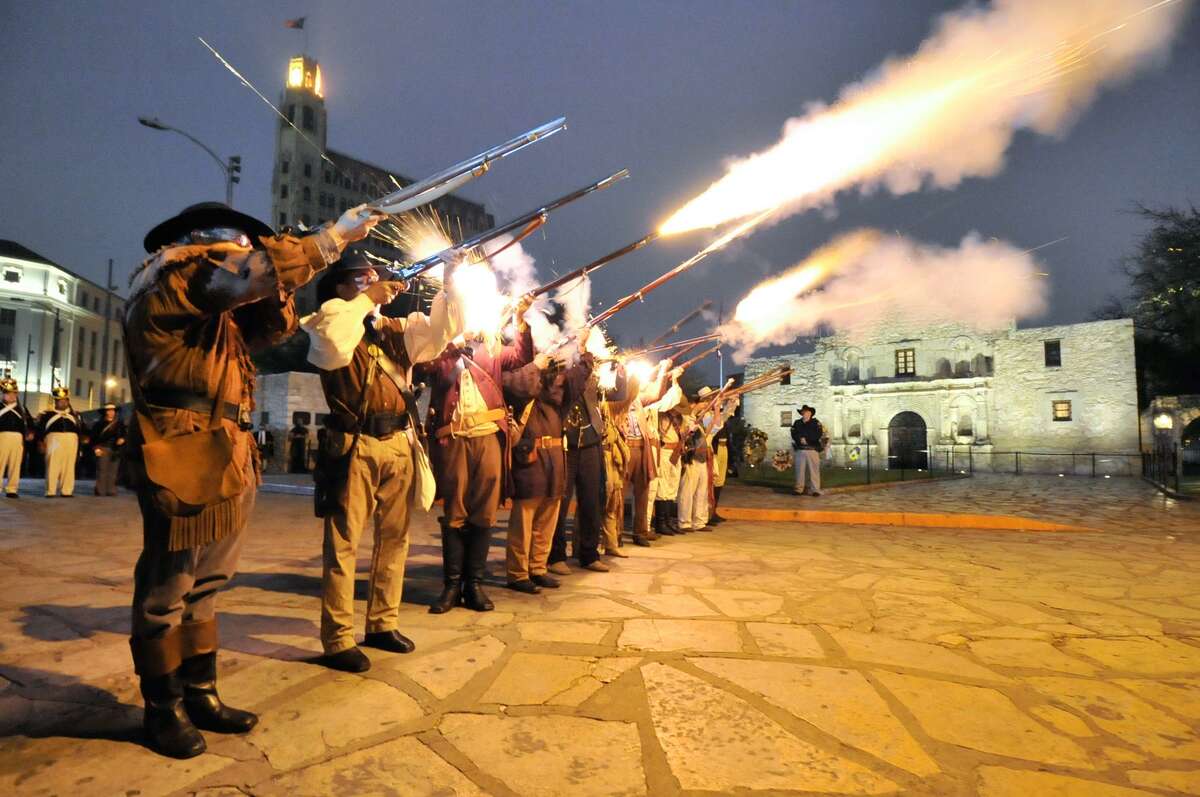 Re-enactors and descendants of the Alamo fire musket volley during Sunday morning's Dawn at the Alamo ceremony.