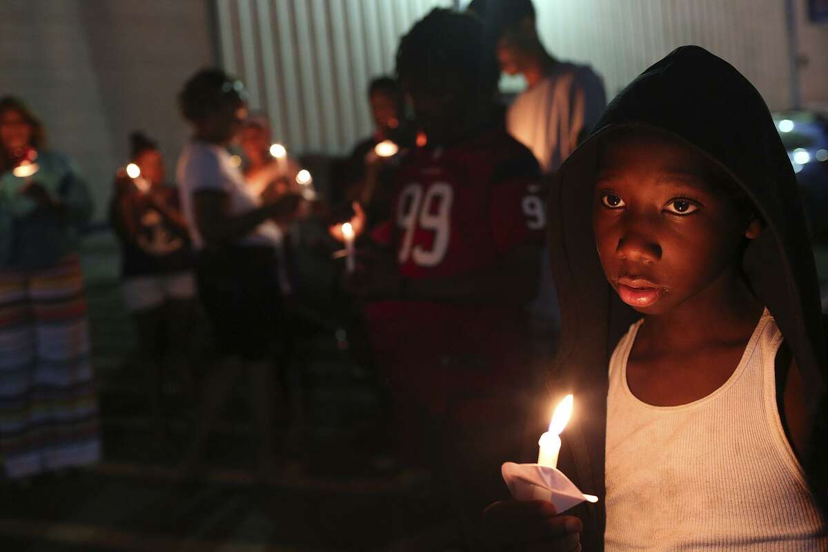 Nac'eir Bell, 11, joins friends, family and supporters of Marquise Jones during the vigil for the third anniversary of Jones' death outside Chacho's restaurant in San Antonio on Tuesday, Feb. 28, 2017.