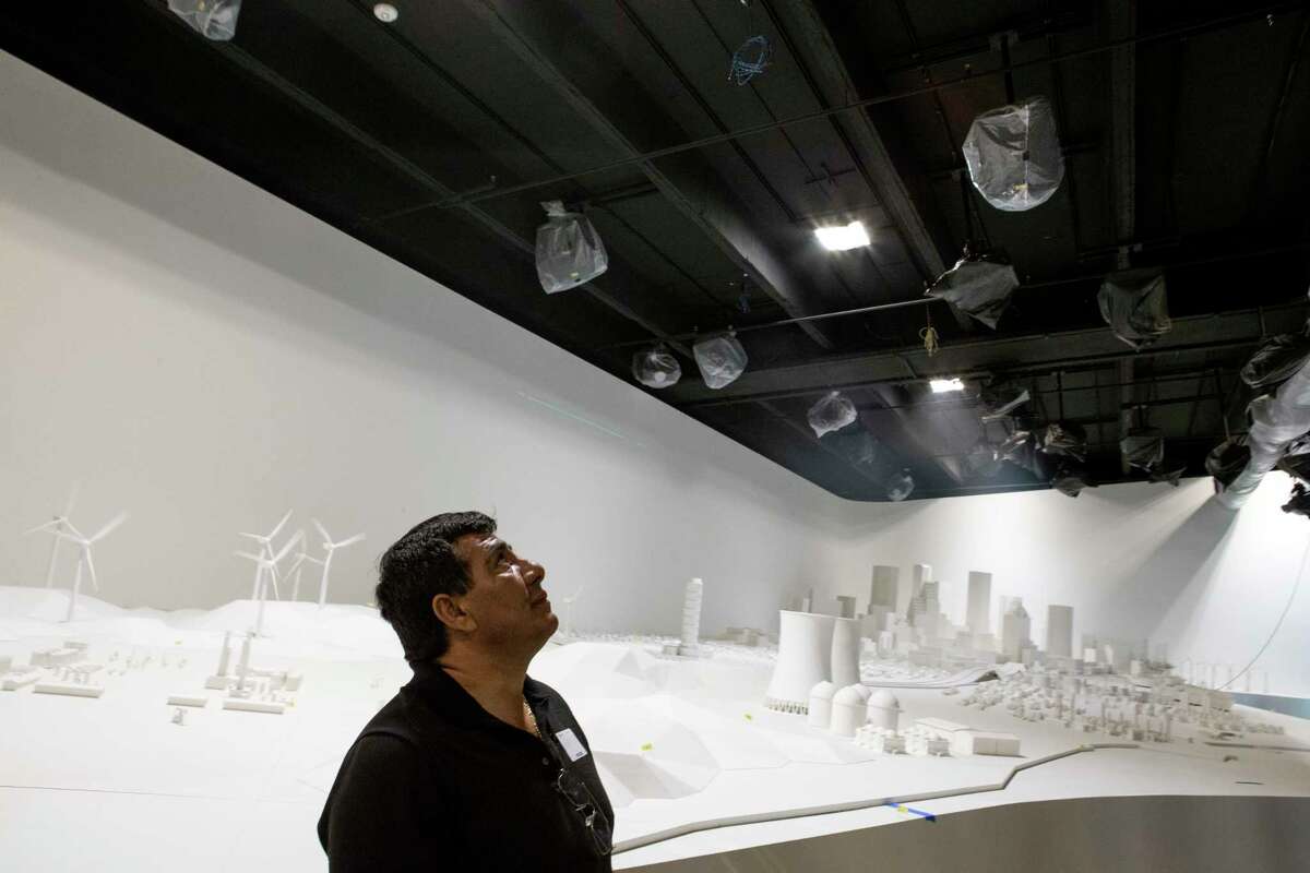 Esteban Gonzalez examines the 2,500-square-foot "Energy City" exhibit in the new Wiess Energy Hall. Once completed, the model landscape will represent Houston, the Gulf coastal water and part of southeast Texas and will be illuminated by a series of projectors.﻿
