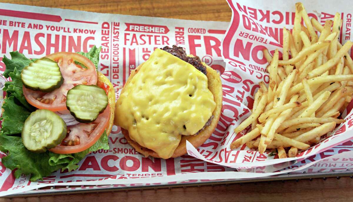 Classic smash burger with smash fries are seen at a Smashburger on in Colonie, NY. The fast food chain is offering a pass where customers can purchase daily burgers or entree items for $1 for 54 days straight.