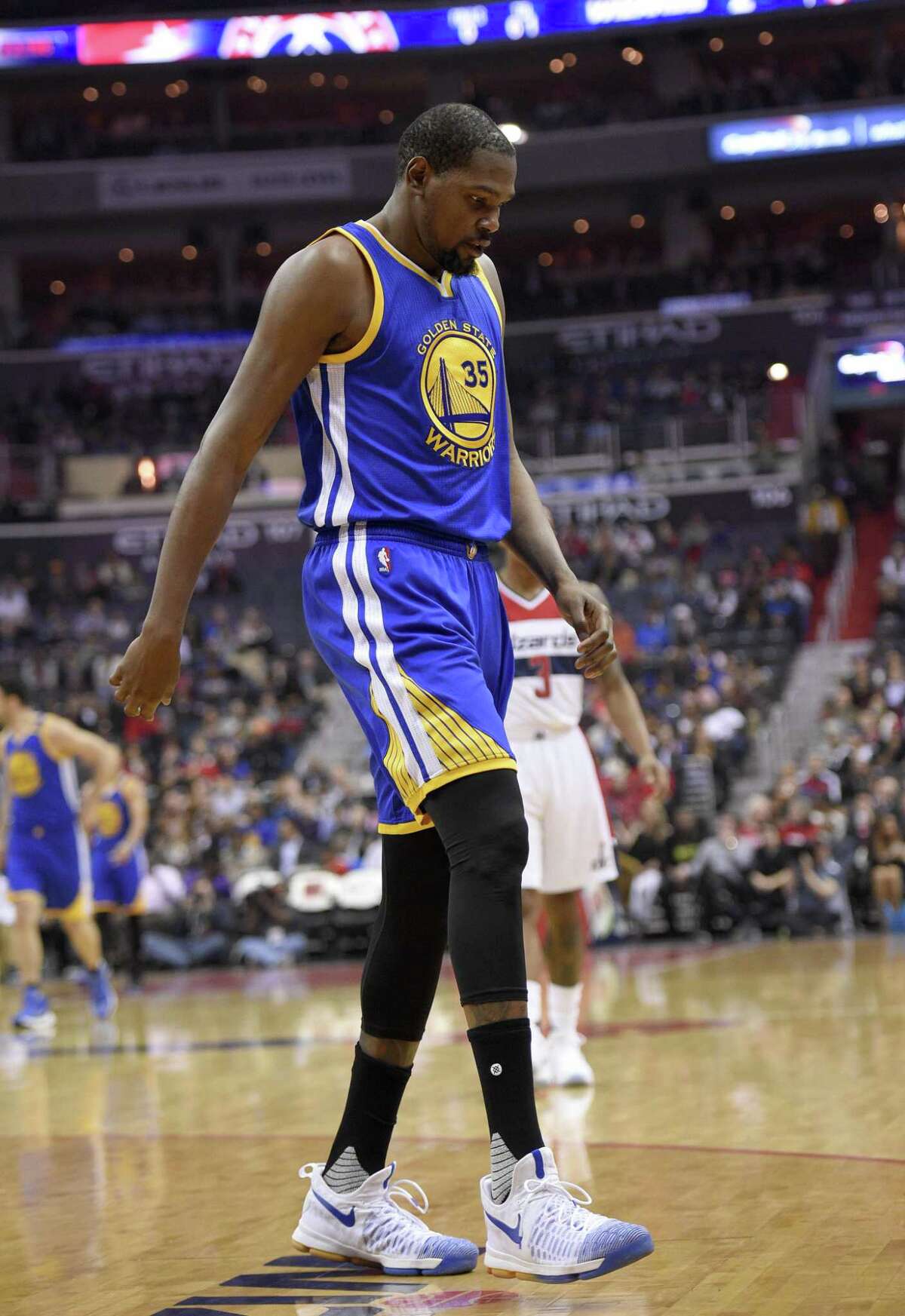 Kevin Durant walks to the bench after hyperextending his left knee Feb. 28 at Washington.