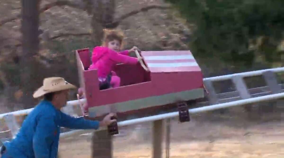 Jimmy White (left) built a backyard amusement park for his 2-year-old granddaughter Sophia (right). 
