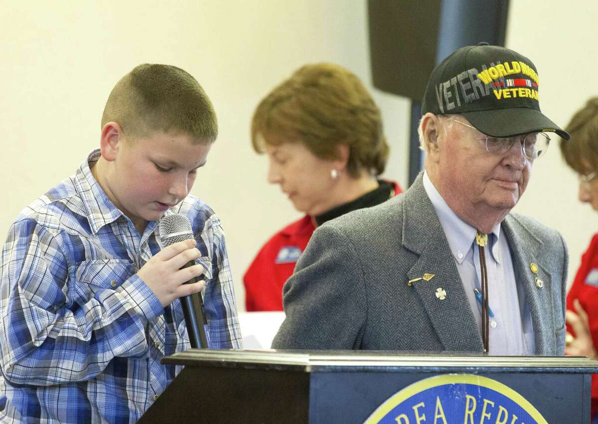Fifth grader Braden Tedder, left, talks about local World War II veteran Charles Trotter, Sr., whom he wrote his 'My American Hero' essay about, during a Lake Conroe Area Republican Women club meeting at April Sound Country Club Thursday, March 2, 2017, in Montgomery.