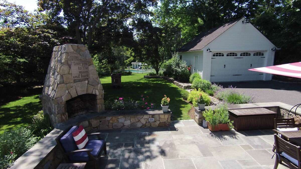 Many improvements were made to the property as well as the house. The backyard includes an in-ground swimming pool at the far end and closer to the house is a bluestone patio with an outdoor fireplace and stone sitting wall.