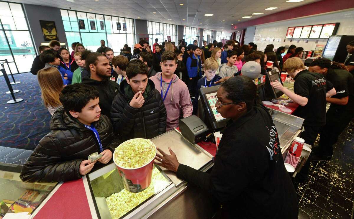 Nathan Hale Middle School students throng the lobby of the Bow Tie Regent theater in South Norwalk, Conn., during a Jan. 27, 2017 field trip. Ridgefield-based Bow Tie Cinemas is undertaking a multimillion-dollar upgrade of Bow Tie Regent, to include new seating.