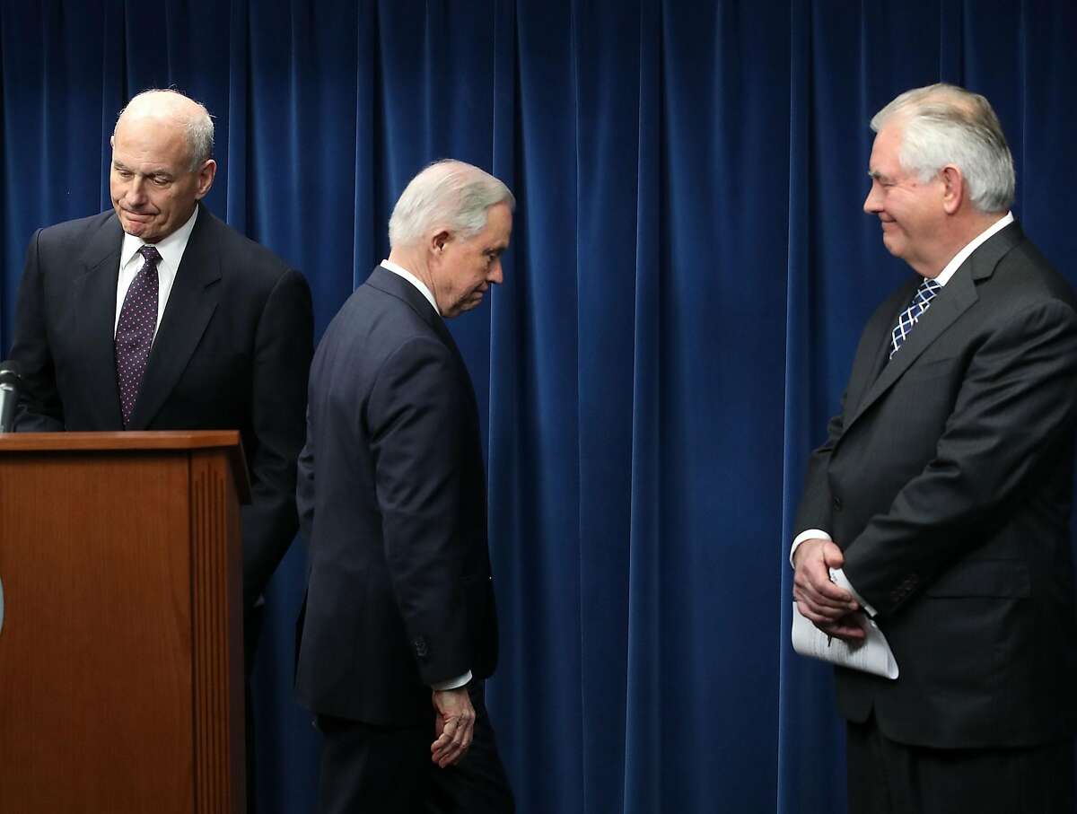 CORRECTED VERSION - WASHINGTON, DC - MARCH 06: Attorney General Jeff Sessions (R), Secretary of Homeland Security John Kelly (L) and Secretary of State Rex Tillerson (C) take part in a news conference about issues related to a reconstituted travel ban at the U.S. Customs and Borders Protection headquarters, on March 6, 2017 in Washington, DC. Earlier today, President Donald Trump signed an executive order that excludes Iraq from the blacklisted countries but continues to block entry to the U.S. for citizens of Somalia, Sudan, Syria, Iran, Libya and Yemen. Kelly, Tillerson and Sessions left the news conference without taking questions. (Photo by Mark Wilson/Getty Images)