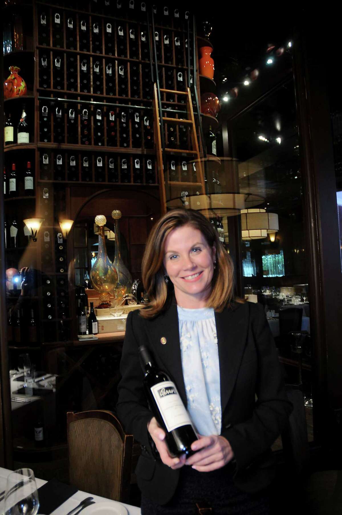 Susi Zivanovic with a bottle of Perry's Sonoma County Cabernet Sauvignon 2013 Reserve at Perry's Steakhouse Memorial City Wednesday Feb. 15, 2017.(Dave Rossman photo)