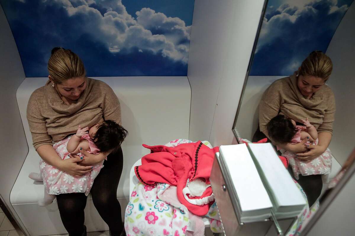 Mavet Coronel (center) breastfeeds her daughter Allison Coronel, 6 months in the lactation pod at City Hall in San Francisco, California, on Monday, March 6, 2017.