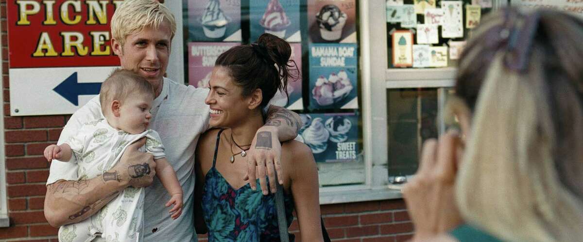 This film image released by Focus Features shows Ryan Gosling and Eva Mendes in front of the Dairy Circus in Scotia during 2011 filming of "The Place Beyond the Pines." (AP Photo/Focus Features)