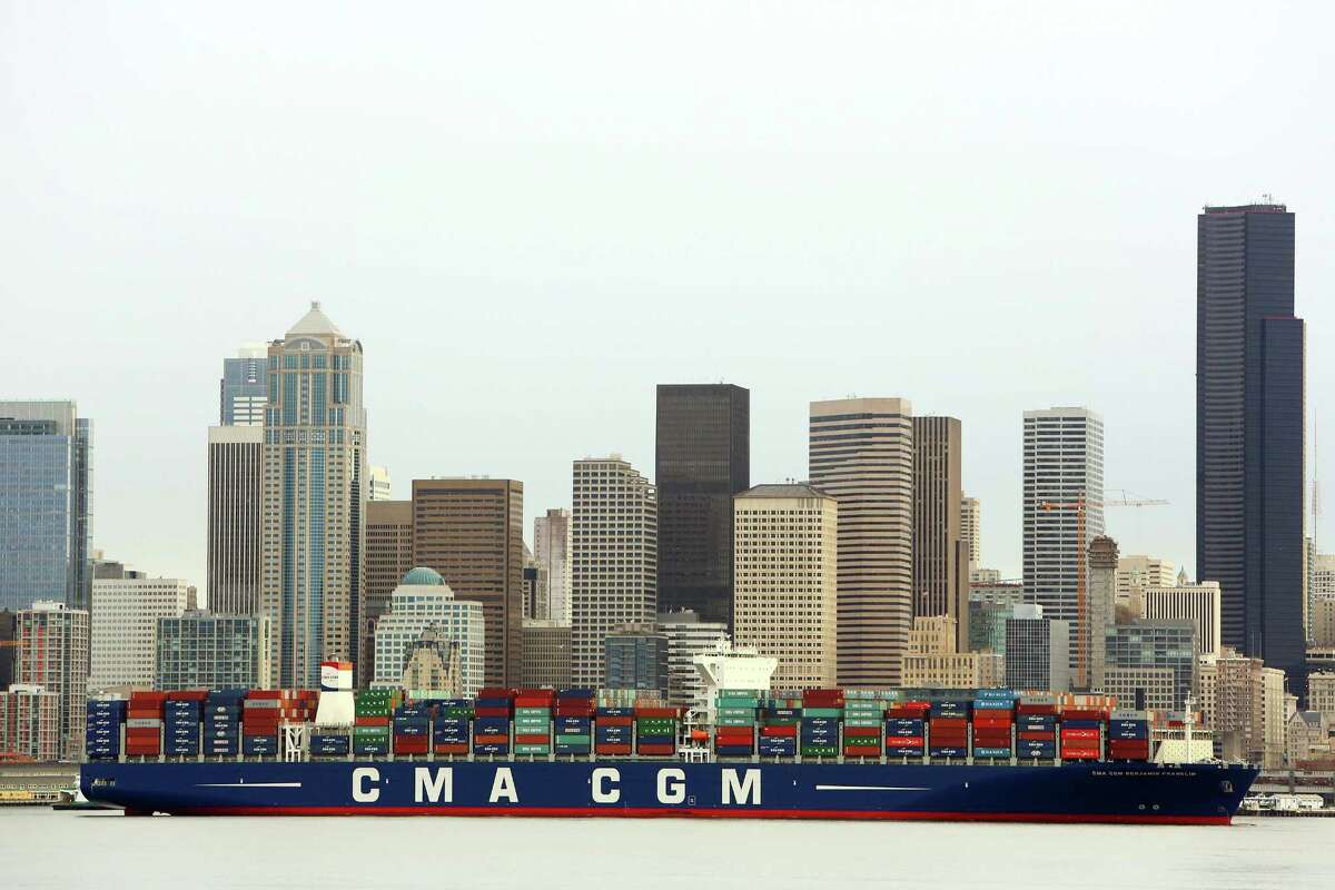 A cargo ship is towed to Seattle’s Terminal 18. The U.S. trade deficit jumped in January to the highest level in nearly five years as a flood of mobile phones and other consumer products widened America’s trade gap with China.