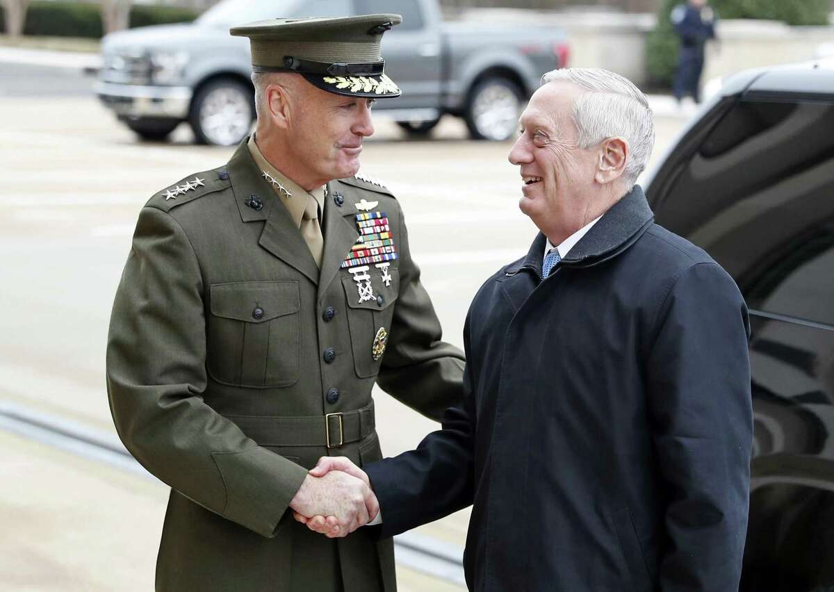 FILE - In this Jan. 21, 2107 file photo, Joint Chiefs Chairman Gen. Joseph Dunford greets Defense Secretary Jimn Mattis at the Pentagon. A new military strategy to meet President Donald Trump?’s demand ?“to obliterate?” the Islamic State group is likely to deepen U.S. military involvement in Syria, possibly with more ground troops, even as the current U.S. approach in Iraq appears to be working and will require fewer changes. Dunford said Feb. 23 that the strategy will take aim not just at the Islamic State but at al-Qaida and other extremist organizations in the Middle East and beyond whose goal is to attack the United States. He emphasized that it would not rest mainly on military might. (AP Photo/Alex Brandon, File)