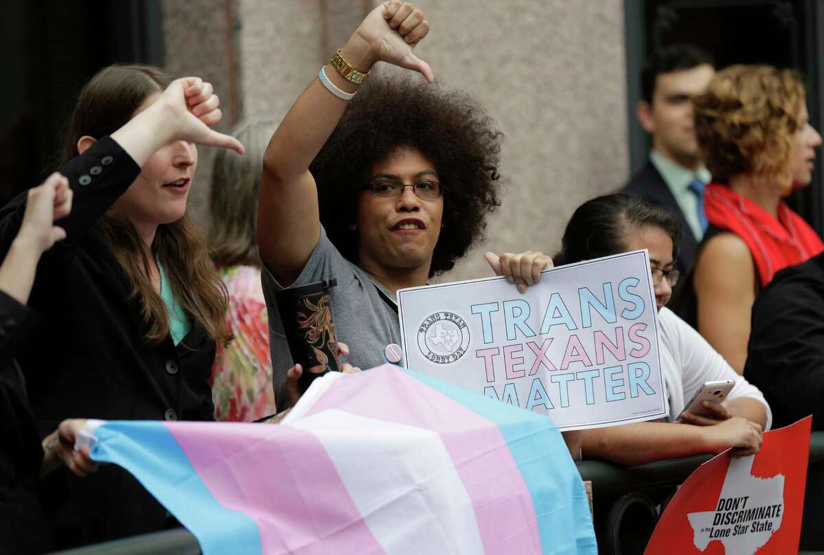 Nicole Perry joins other members of the transgender community who oppose Senate Bill 6 in a protest at the Texas Capitol as the Senate State Affairs Committee holds hearings on the bill, Tuesday, March 7, 2017, in Austin, Texas. The transgender "bathroom bill" would require people to use public bathrooms and restrooms that correspond with the sex on their birth certificate. (AP Photo/Eric Gay)