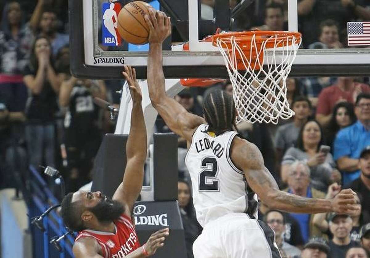 The Spurs’ Kawhi Leonard blocks the shot attempt of the Rockets’ James Harden in the waning moments of the March 6, 2017, game at the AT&T Center.