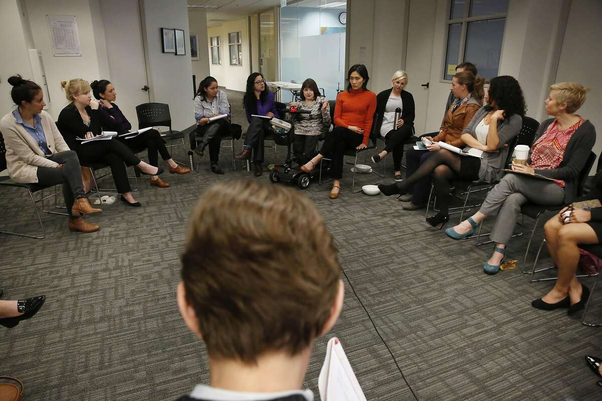 Elizabeth Kristen (bottom), Legal Aid At Work director gender equality and LGBT rights program; sits in a cirlce with others after small breakout session, during a brainstorming session to support "A Day Without A Woman" �and other resistance events at the Legal Aid At Work office on Tuesday, March 7, 2017 in San Francisco, Calif.