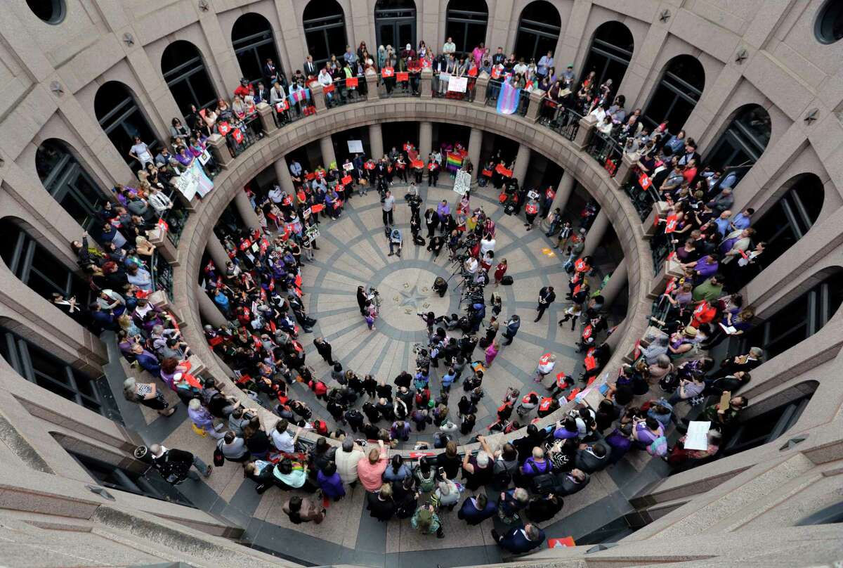 Members of the transgender community and others who oppose Senate Bill 6, known as the "bathroom bill," protest in the exterior rotunda at the state Capitol during the Senate State Affairs Committee hearing.﻿