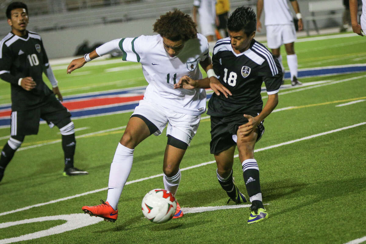 The WoodlandsÂ?’ Andy Mitchell (11) moves the ball as ConroeÂ?’s Josafat Hernandez (18) defends during the varsity boys soccer game on Tuesday, March 7, 2017, at Woodforest Bank Stadium. (Michael Minasi / Chronicle)